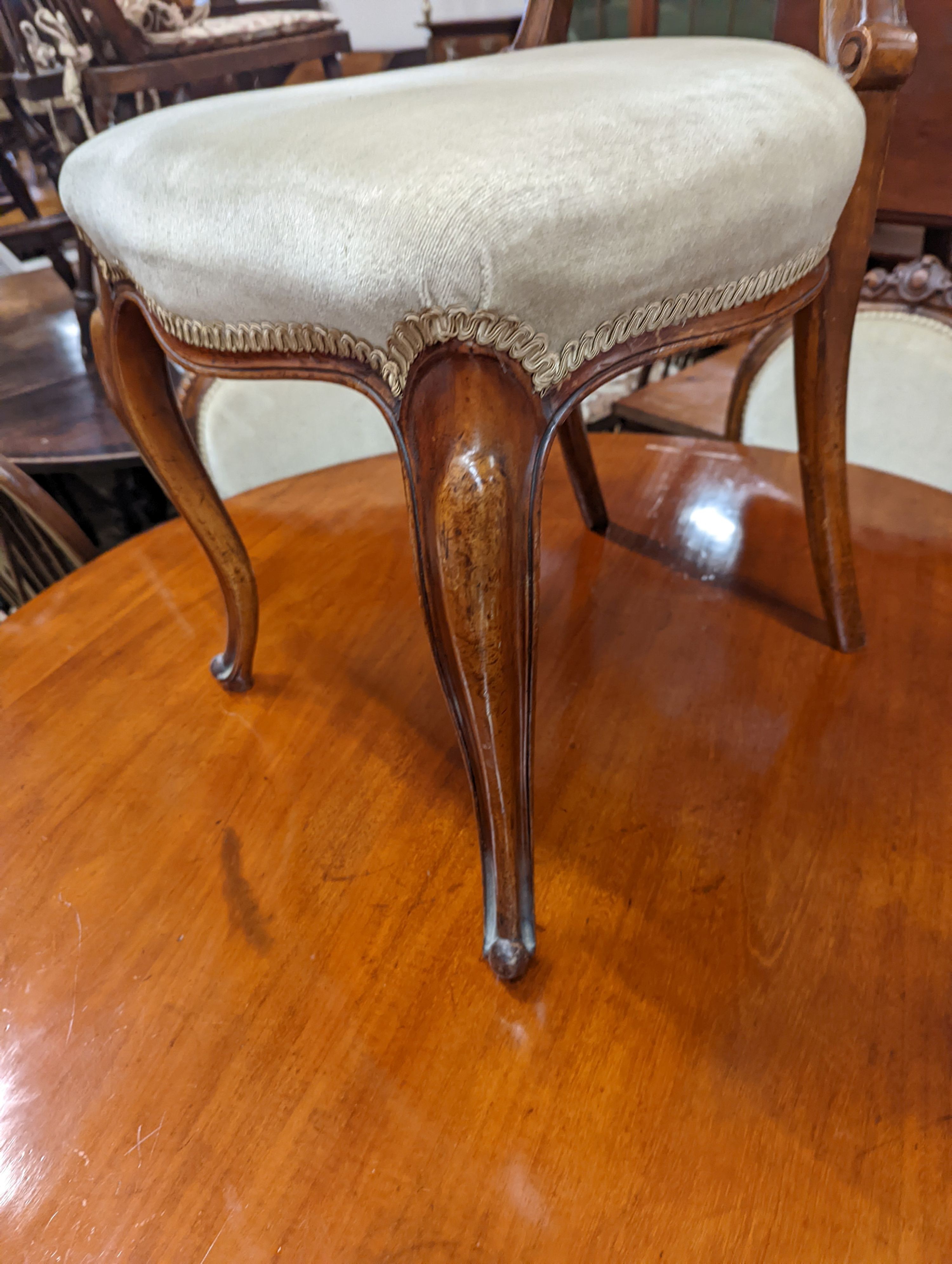 A set of six Victorian mahogany upholstered balloon back dining chairs together with a Victorian mahogany circular breakfast table, diameter 118cm, height 72cm